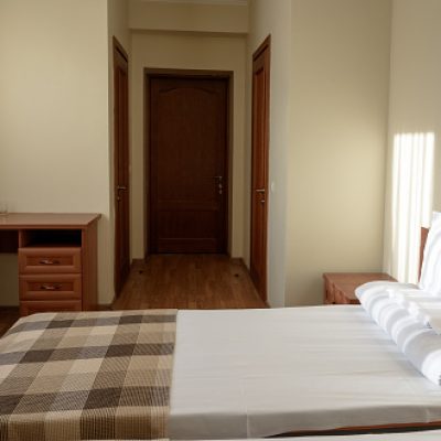 interior of comfortable budget hotel bedroom with bed